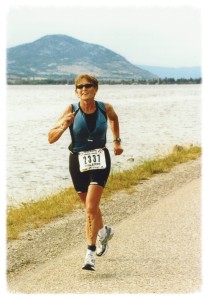 Valerie Gonzales running in an Ironman Canada race along the shore of Skaha Lake, BC